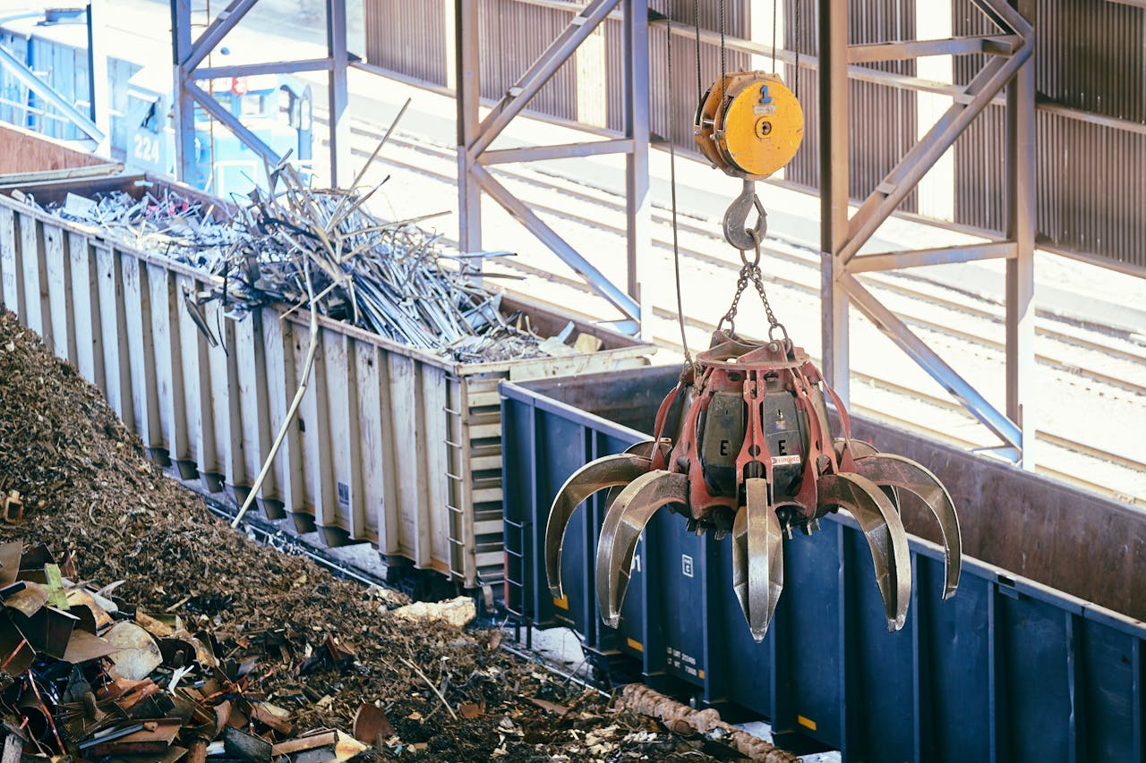 portfolio-01 Overhead crane sorting scrap metal in an industrial recycling facility.